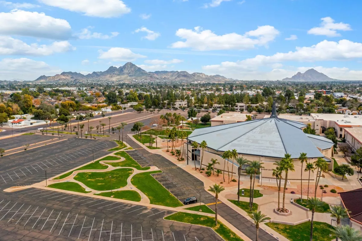 Aerial view of large event venue, parking lots, and mountain backdrop.
