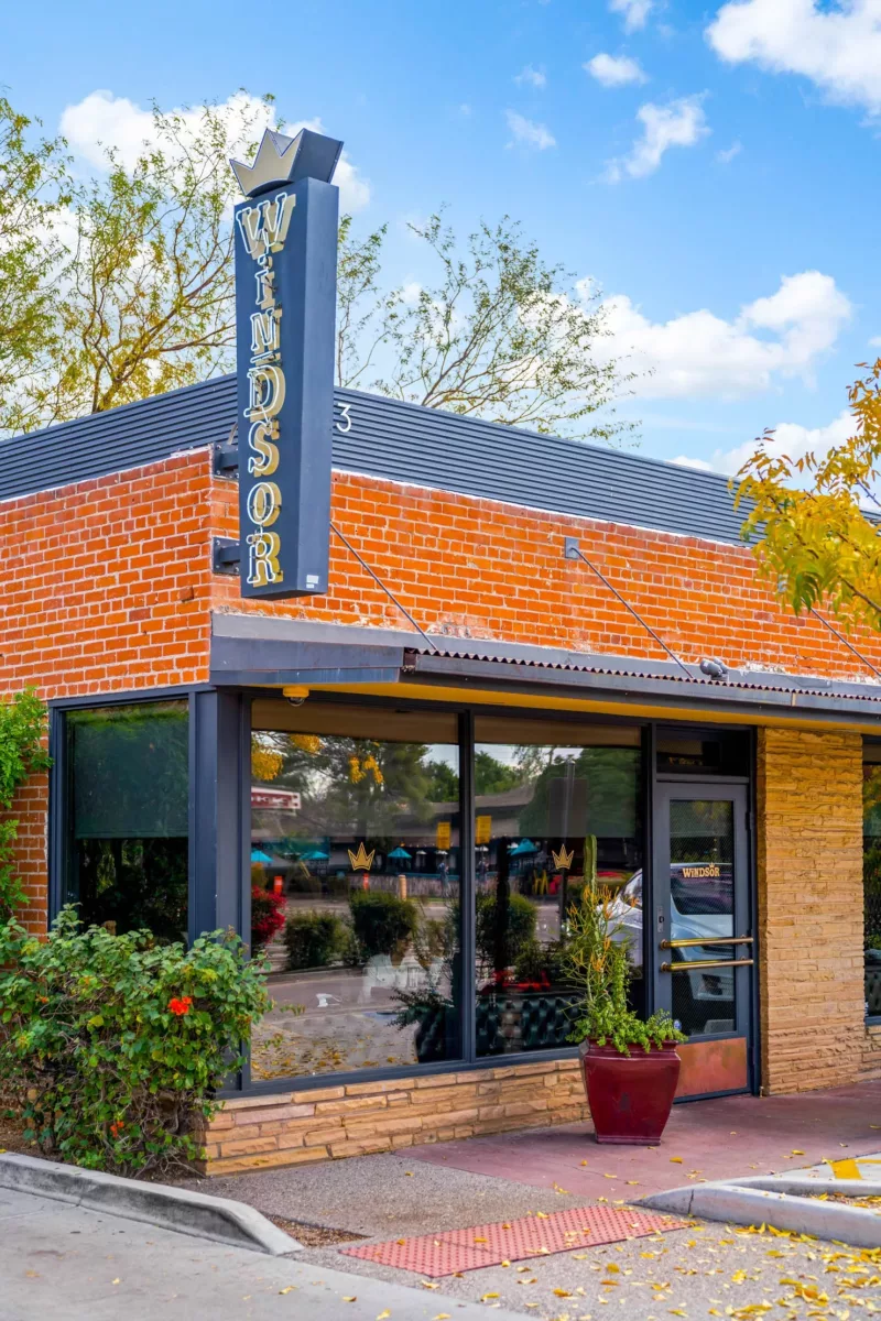 Windsor storefront with brick facade, large windows, and entry planter.