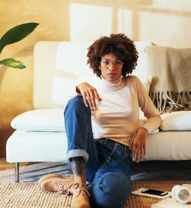 Woman sitting in front of couch